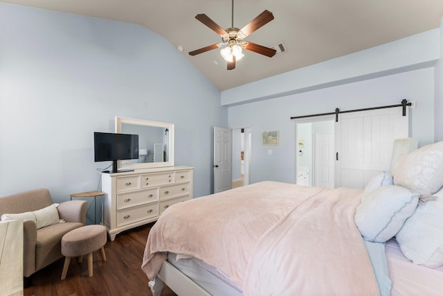 bedroom with dark wood finished floors, high vaulted ceiling, a barn door, and a ceiling fan