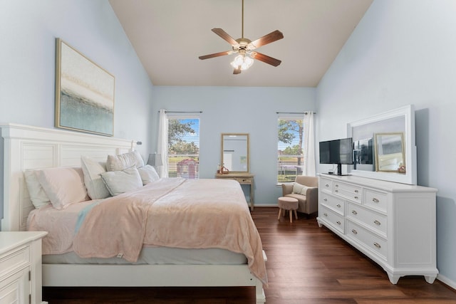 bedroom with dark wood-type flooring, baseboards, ceiling fan, and high vaulted ceiling