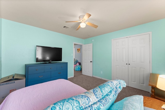 carpeted bedroom with a closet, baseboards, and a ceiling fan