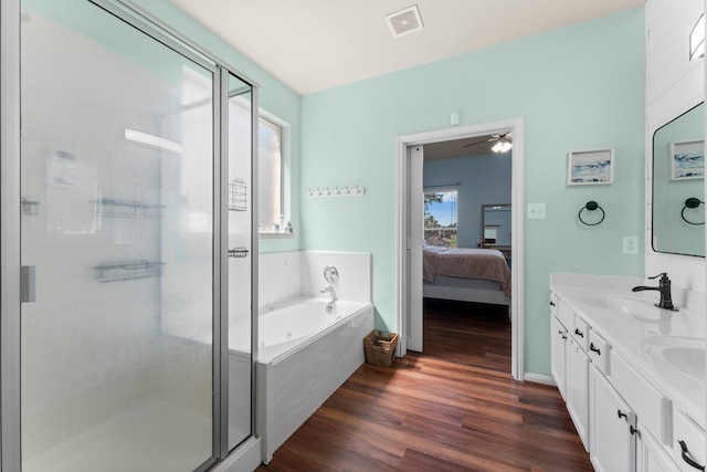 bathroom with wood finished floors, a bath, ensuite bathroom, and a stall shower