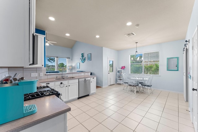 kitchen featuring stainless steel dishwasher, a sink, recessed lighting, white cabinets, and ceiling fan