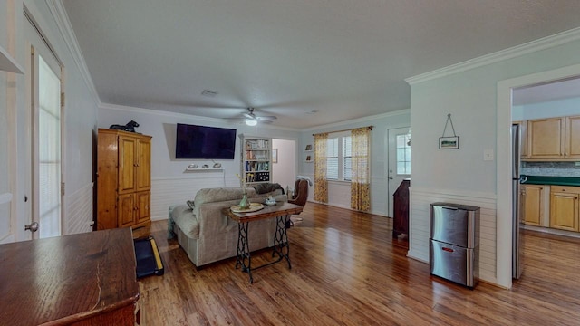 129 County Road 2063, Hull, TX 77564 - living room featuring wood finished floors, a ceiling fan, and ornamental molding