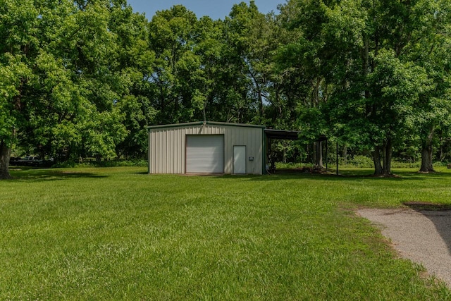 129 County Road 2063, Hull, TX 77564 - view of outbuilding with an outdoor structure, driveway, and view of wooded area