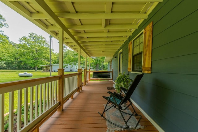 129 County Road 2063, Hull, TX 77564 - wooden deck featuring a porch and a lawn