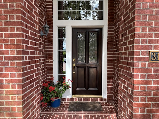 property entrance with brick siding