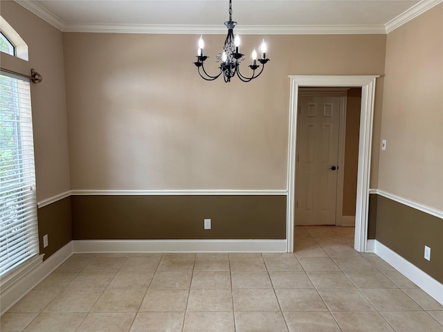 spare room with a chandelier, ornamental molding, light tile patterned floors, and baseboards