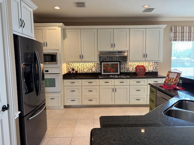 kitchen featuring stainless steel appliances, light tile patterned floors, ornamental molding, backsplash, and under cabinet range hood
