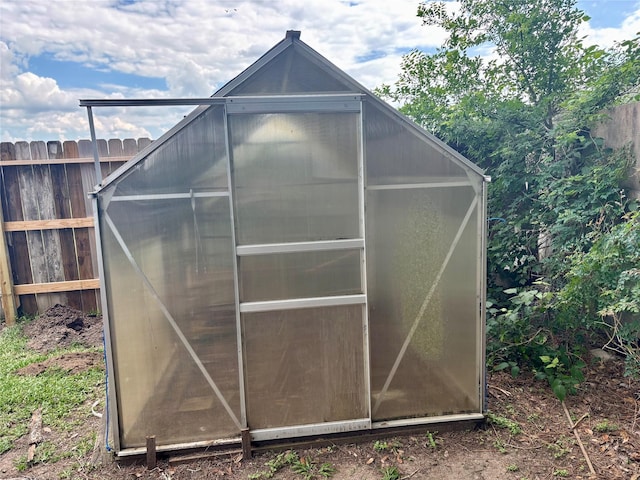 view of greenhouse with fence