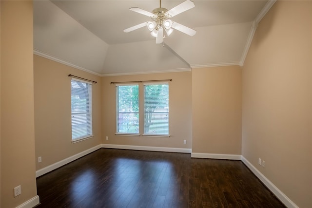 empty room with a ceiling fan, vaulted ceiling, dark wood finished floors, baseboards, and ornamental molding