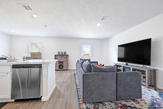 1325 Rd 5102, Cleveland, TX 77327 - living area featuring baseboards, light wood-style flooring, recessed lighting, and a textured ceiling