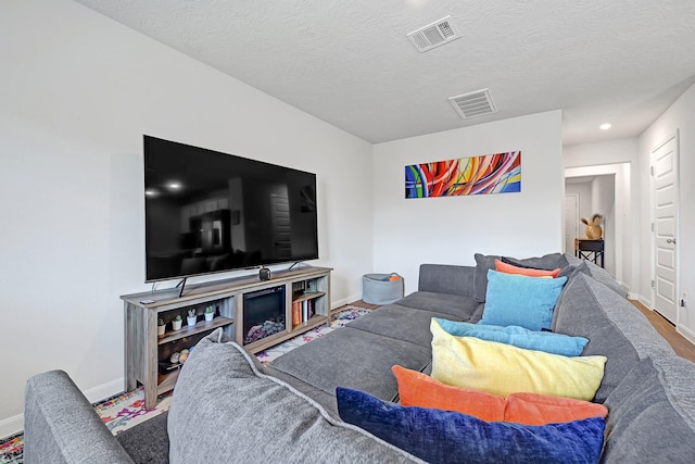 1325 Rd 5102, Cleveland, TX 77327 - living room with baseboards, a textured ceiling, and recessed lighting
