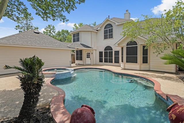 view of swimming pool featuring a patio area and a pool with connected hot tub