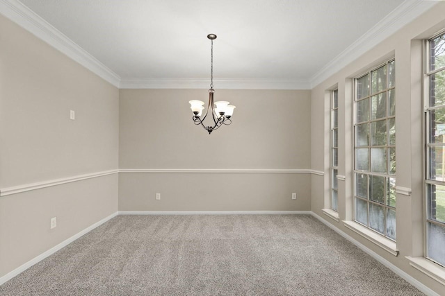 carpeted spare room with ornamental molding, a chandelier, and baseboards