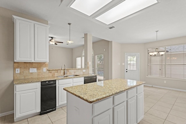 kitchen with a sink, black dishwasher, light tile patterned floors, and baseboards
