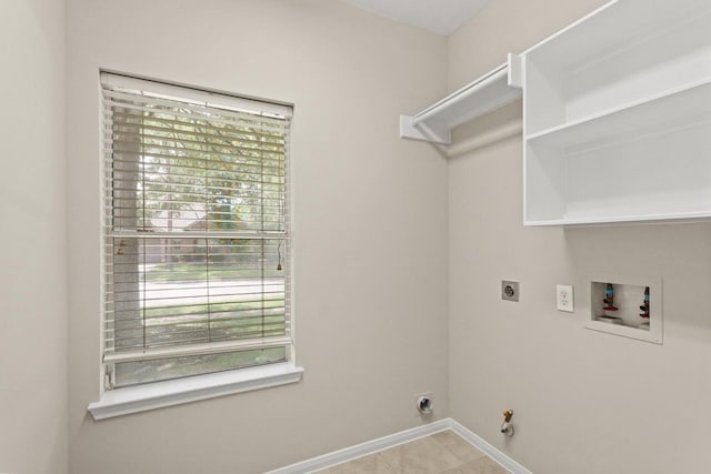 clothes washing area featuring hookup for an electric dryer, washer hookup, hookup for a gas dryer, baseboards, and tile patterned flooring