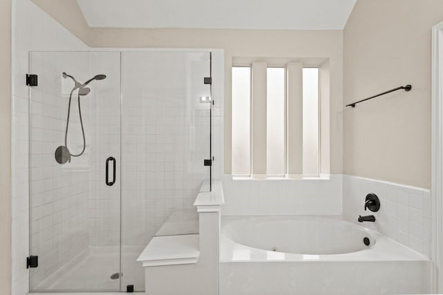 full bathroom featuring a stall shower and a garden tub