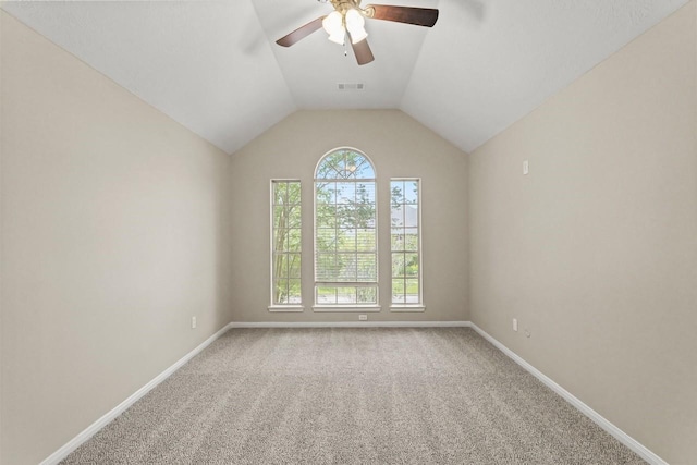 carpeted spare room with healthy amount of natural light, a ceiling fan, baseboards, and lofted ceiling