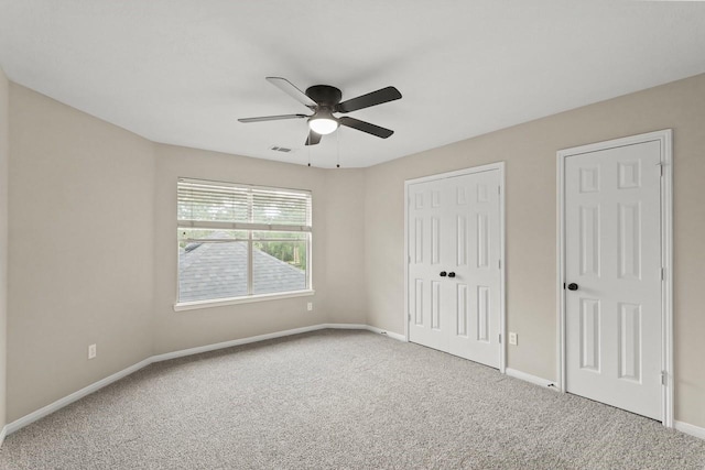 unfurnished bedroom featuring carpet floors, baseboards, and ceiling fan