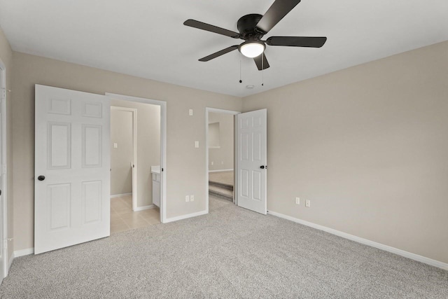 unfurnished bedroom featuring light colored carpet, baseboards, and ceiling fan