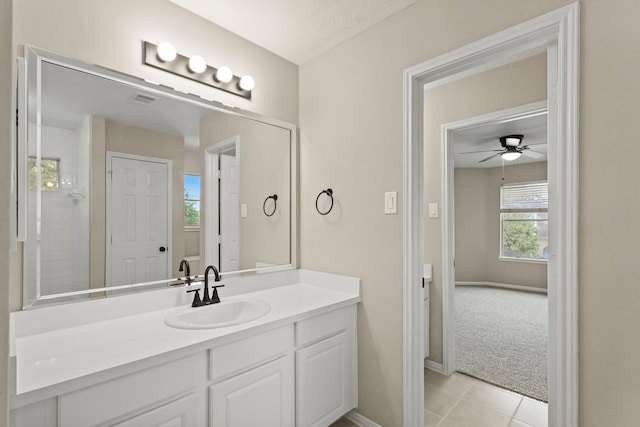bathroom featuring tile patterned floors, a ceiling fan, vanity, and baseboards