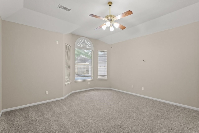 spare room with carpet floors, ceiling fan, baseboards, and vaulted ceiling