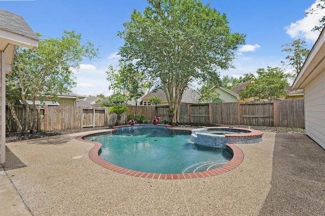 view of swimming pool with a pool with connected hot tub, a patio, and a fenced backyard