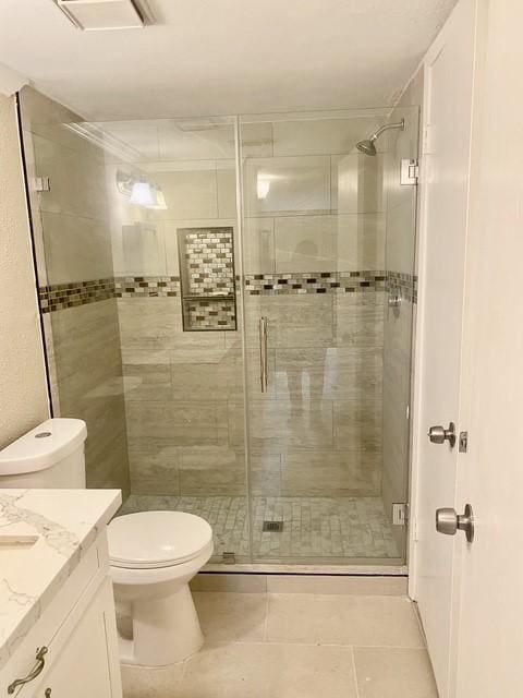 11957 Bob White Dr Unit 863, Houston, TX 77035 - bathroom featuring a shower stall, vanity, toilet, and tile patterned flooring