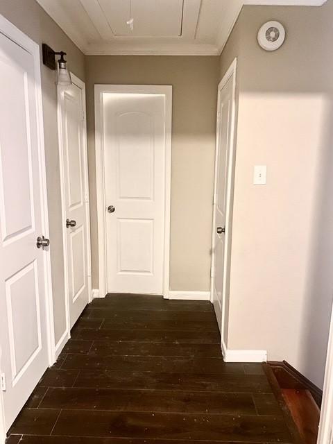 11957 Bob White Dr Unit 863, Houston, TX 77035 - hallway featuring attic access, dark wood finished floors, ornamental molding, and baseboards