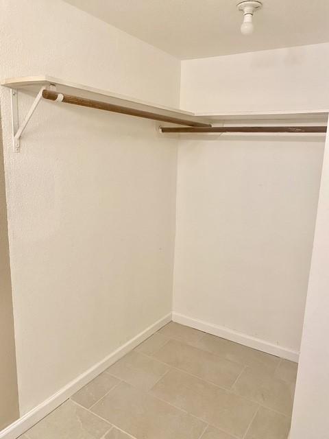 11957 Bob White Dr Unit 863, Houston, TX 77035 - spacious closet featuring light tile patterned floors