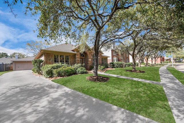 1119 Summer Brk, Sugar Land, TX 77479 - view of front facade with brick siding, a front lawn, driveway, and roof with shingles