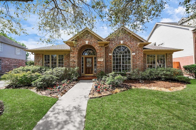 1119 Summer Brk, Sugar Land, TX 77479 - traditional home with brick siding, a front yard, and a shingled roof