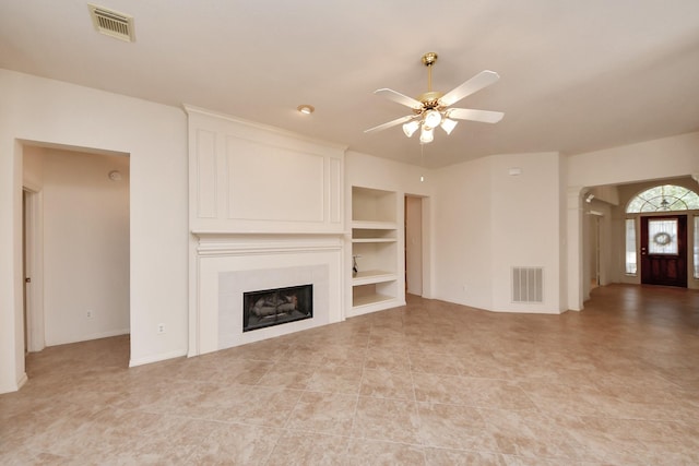 1119 Summer Brk, Sugar Land, TX 77479 - unfurnished living room with ceiling fan, a tiled fireplace, built in features, and light tile patterned floors