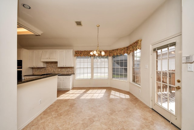 1119 Summer Brk, Sugar Land, TX 77479 - kitchen featuring plenty of natural light, dark countertops, a chandelier, and decorative backsplash