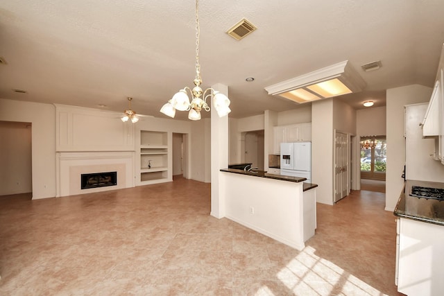 1119 Summer Brk, Sugar Land, TX 77479 - kitchen featuring white refrigerator with ice dispenser, dark countertops, white cabinetry, and a fireplace