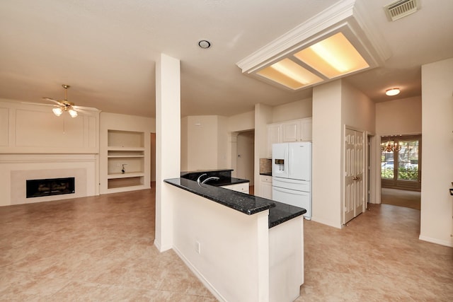 1119 Summer Brk, Sugar Land, TX 77479 - kitchen featuring white fridge with ice dispenser, white cabinets, ceiling fan, a peninsula, and dark stone counters