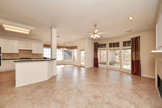 1119 Summer Brk, Sugar Land, TX 77479 - kitchen with dark countertops, a fireplace, ceiling fan, and open floor plan