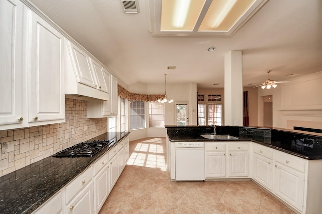 1119 Summer Brk, Sugar Land, TX 77479 - kitchen with dishwasher, a sink, gas stovetop, decorative backsplash, and white cabinets