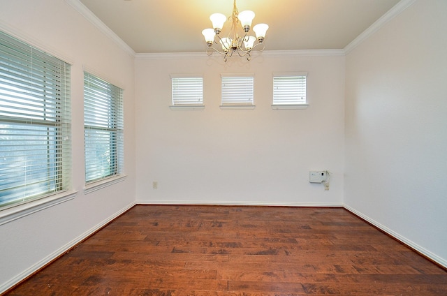 spare room with crown molding, a chandelier, wood finished floors, and baseboards