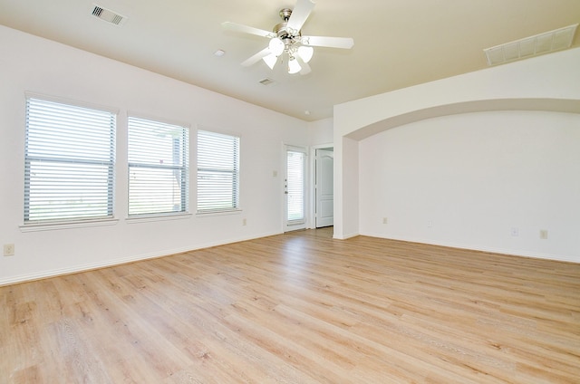 unfurnished room featuring light wood-style floors, ceiling fan, and baseboards