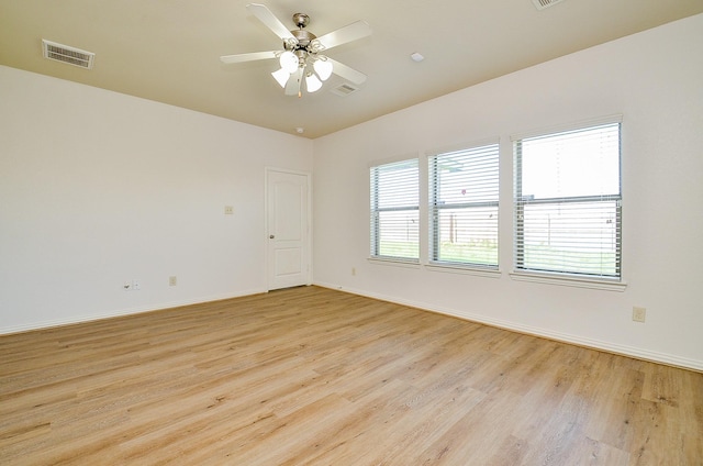 empty room with light wood-style flooring, baseboards, and a ceiling fan
