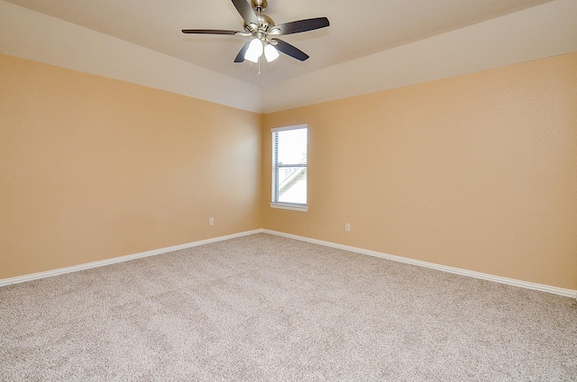 empty room with carpet, baseboards, and a ceiling fan