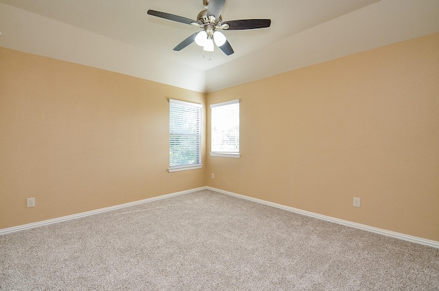 unfurnished room with carpet floors, ceiling fan, baseboards, and lofted ceiling
