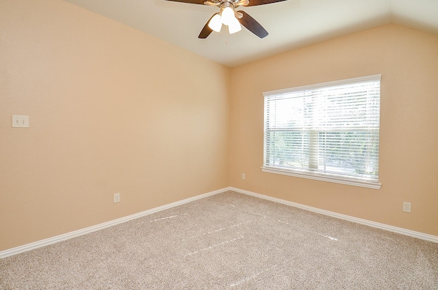 unfurnished room featuring ceiling fan, carpet floors, baseboards, and lofted ceiling
