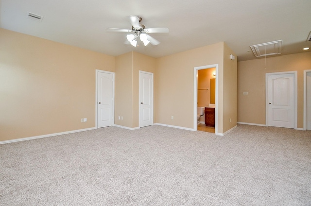 unfurnished bedroom featuring attic access, light carpet, baseboards, and connected bathroom
