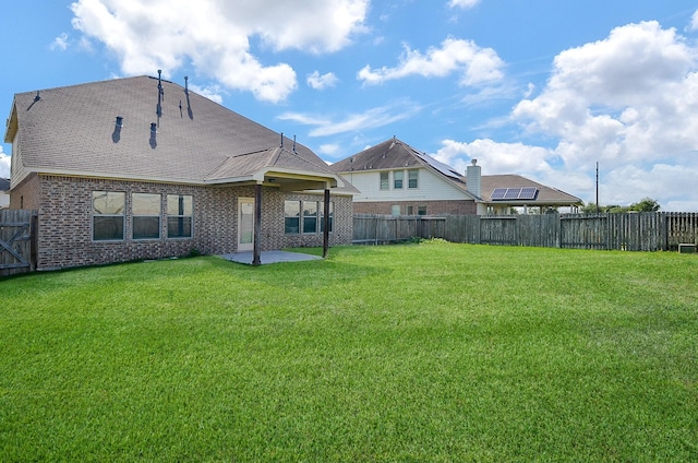 rear view of property with brick siding and a patio area