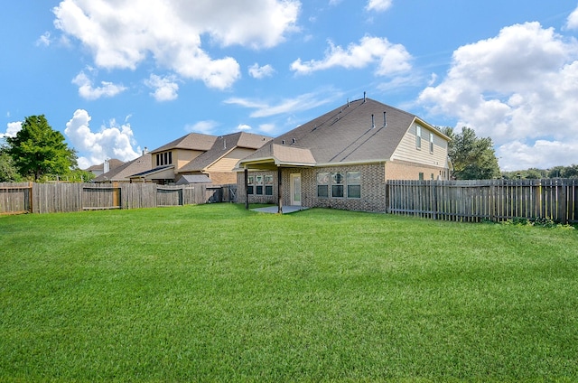 rear view of house with brick siding and a patio