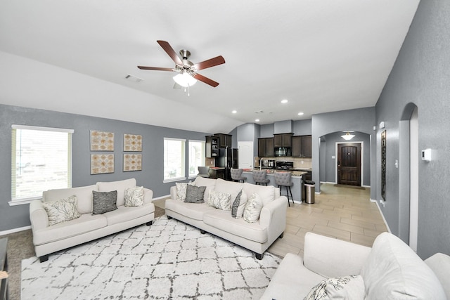 7215 Cypress Pin Oak Dr, Cypress, TX 77433 - living room with arched walkways, a ceiling fan, lofted ceiling, recessed lighting, and baseboards