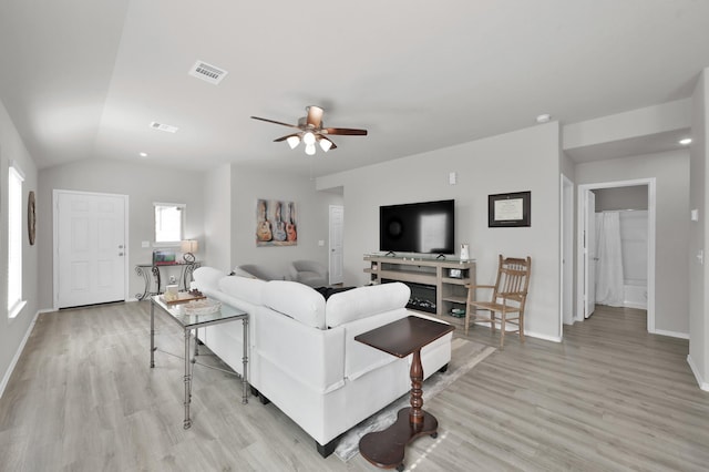 8230 Red Spruce St, Magnolia, TX 77354 - living room with light wood-style floors, ceiling fan, baseboards, and lofted ceiling