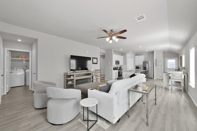 8230 Red Spruce St, Magnolia, TX 77354 - living area featuring washer / dryer, a ceiling fan, light wood-style floors, recessed lighting, and lofted ceiling