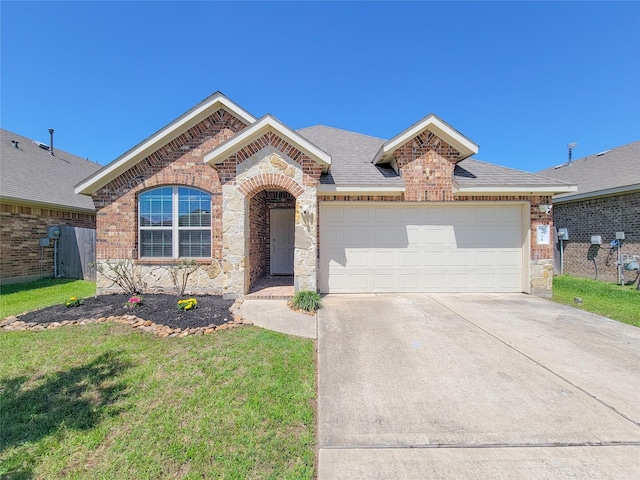 4931 Marina Shores Ct, Katy, TX 77493 - view of front of house featuring brick siding, concrete driveway, an attached garage, and stone siding